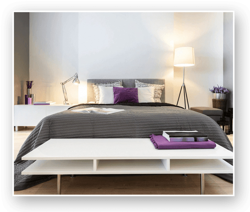 A bed room with a white and purple bedspread